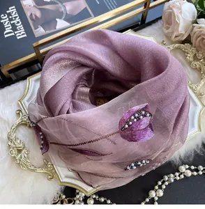 Detail of lavender silk blend scarf featuring tulip embroidery and beaded pearls