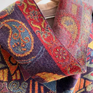 Detail of thick winter scarf featuring colorful paisley patterns and soft knitted texture
