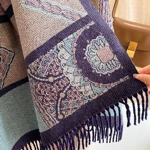 Close-up of bohemian knit shawl detailing purple fringe edges and ethnic floral patterns
