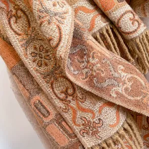 Detail of thick jacquard knit fabric with vintage patterns and fringe edges