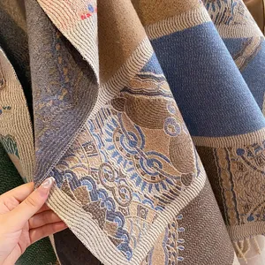 Detailed macro view of bohemian shawl fabric with tassels and intricate woven textures
