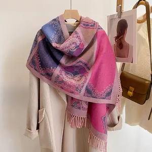 Detail of bohemian pashmina shawl with ethnic floral jacquard and tassel trim edges