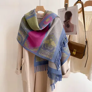 Detail of bohemian shawl with ethnic patterns, thick knit fabric and long tassels