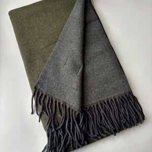 Detailed macro view of olive green and charcoal grey double-sided wool scarf with tassels