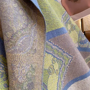 Close-up of bohemian shawl fabric showing intricate jacquard weave and soft texture