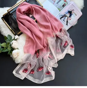 Detail of silk blend scarf featuring exquisite flower embroidery and delicate beading