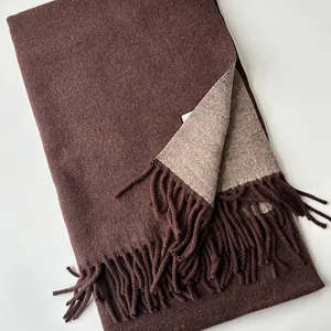 Detail of double-sided wool scarf showing dark coffee color and oatmeal textured fringe