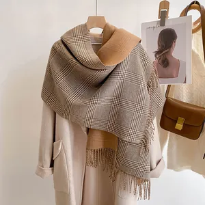 Detail of soft plaid cashmere-feel scarf with fringes on beige coat for autumn