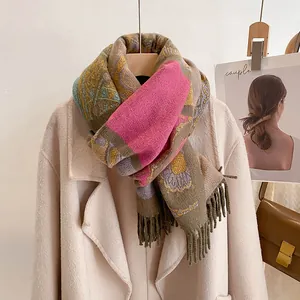 Detail of bohemian scarf showing ethnic print patterns and thick fringe tassels on fabric