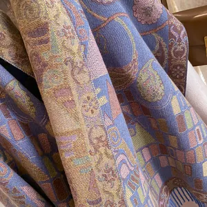 Close-up of bohemian pashmina shawl with intricate blue and gold paisley patterns