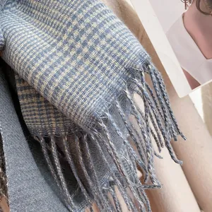 Close-up of thick blue and cream houndstooth pattern scarf with soft fringe detail
