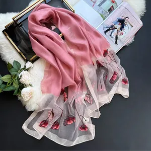 Elegant silk blend scarf in pale pink featuring red floral embroidery and mesh detail