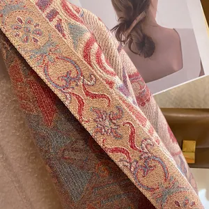 Close-up of thick ethnic jacquard scarf fabric with luxury embroidery texture and warm fringe