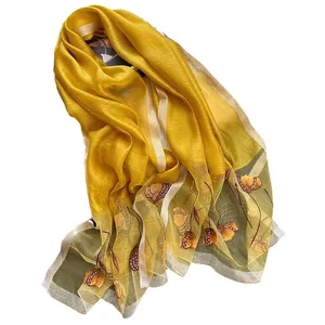 Elegant yellow silk blend scarf with green hem and embroidered tulip floral pattern