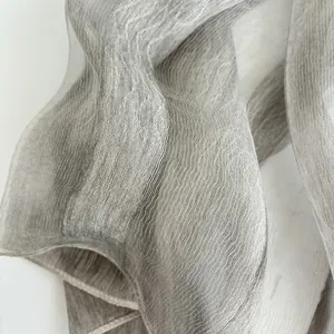 Detail shot of sheer grey silk scarf showing vertical striped texture and fine stitching