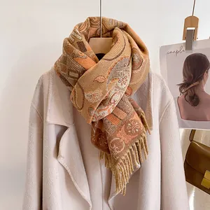 Detailed view of winter jacquard scarf featuring ethnic paisley patterns and tassel edges