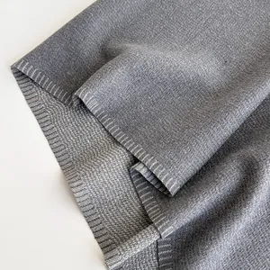 Macro shot of dark grey cashmere-like scarf fabric with fine woven cross texture