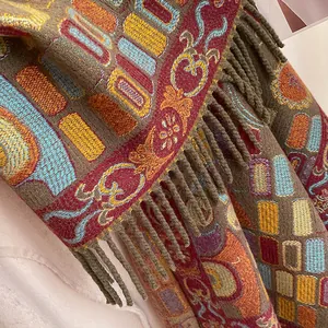 Macro detail of ethnic jacquard scarf with thick fabric texture and brown fringe edges