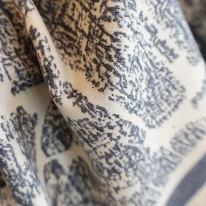 Thick winter cashmere-feel scarf for women with grey jacquard pattern on off-white fabric