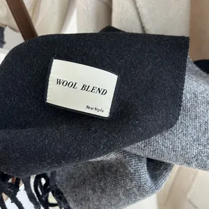 Double-sided wool blend scarf in black and grey with fringe and luxury woven label