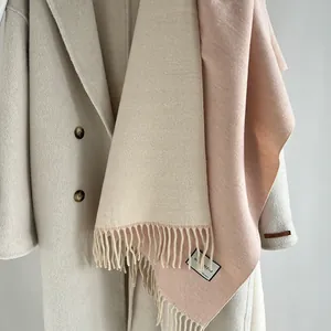 Detail showing the wool blend texture and elegant tassels on a double-sided pashmina scarf