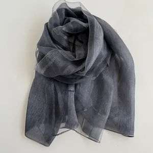 Detail of elegant dark grey sheer silk scarf showing its smooth texture and light drape