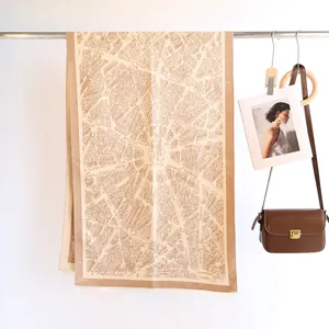Detailed view of khaki imitation cashmere scarf featuring retro city map jacquard and fringe
