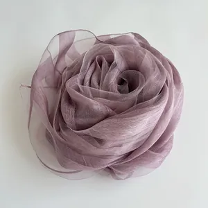 Close-up of elegant purple organza silk scarf shaped as a delicate rose flower accessory