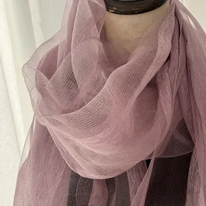 Detail of lavender pleated silk scarf showing lightweight sheer fabric on a mannequin