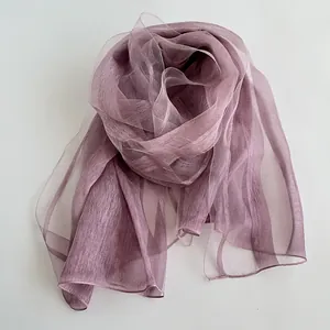 Detail of elegant mauve silk scarf showing sheer chiffon texture and fine edging