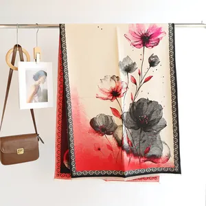 Detailed view of floral cashmere-feel shawl with poppy prints and geometric borders