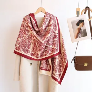 Detail of burgundy pashmina shawl with retro city map pattern and fringe edges