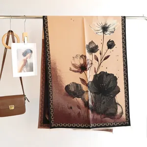Detail of cashmere-feel scarf with ink flower print and fringe in earth tones
