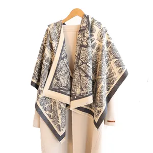 Women's vintage map print cashmere scarf with tassel edges on a wool coat