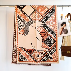 Close-up of jacquard horse pattern and geometric weaving on beige cashmere-like scarf