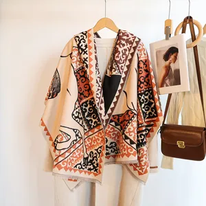 Detail of horse jacquard scarf with HAND MADE label and bohemian tassel fringe