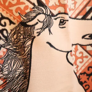 Macro shot of jacquard horse pattern and fabric texture on autumn winter cashmere scarf