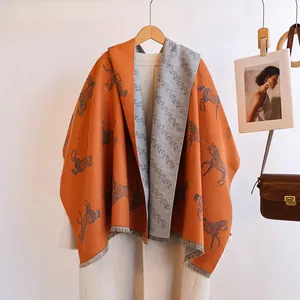 Detail of horse jacquard scarf with orange and grey double-sided cashmere-like texture