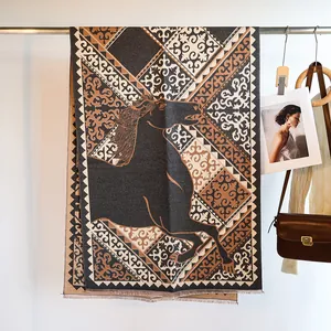 Close-up of jacquard horse pattern and tassel fringe on thick cashmere-like scarf