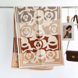 Detail of camellia flower pattern on beige and brown cashmere-feel fringe shawl