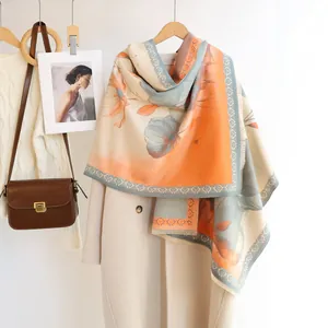Detailed view of floral pattern shawl with soft fringe on an elegant autumn coat