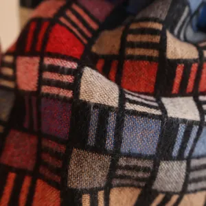 Detailed macro shot of soft brushed fabric texture in classic multi-color plaid patterns