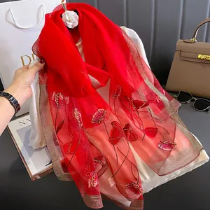 Elegant red silk blend scarf with floral embroidery, gold sequins and camellia brooch