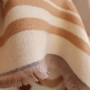 Close-up of soft khaki and cream striped pashmina with delicate fringe details