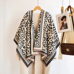 Detail of leopard print scarf featuring thick fabric with elegant fringe edges and trim