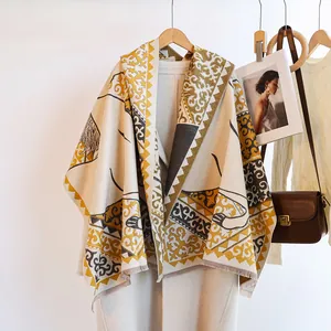 Elegant horse jacquard cashmere scarf styled over a coat with soft warm tones