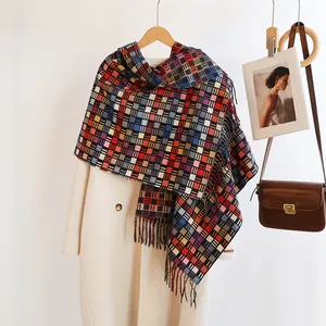 Detail of colorful plaid scarf with fringes styled with a wool coat and leather bag