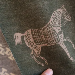 Close-up of luxury horse jacquard cashmere scarf with detailed stitch and thick texture