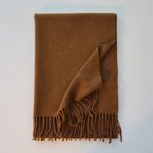 Detailed texture of caramel wool scarf showing thick fabric and fringe tassels