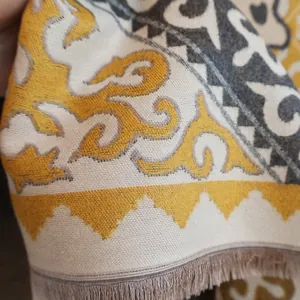 Detail view of jacquard horse pattern scarf with soft fringe and ethnic woven texture